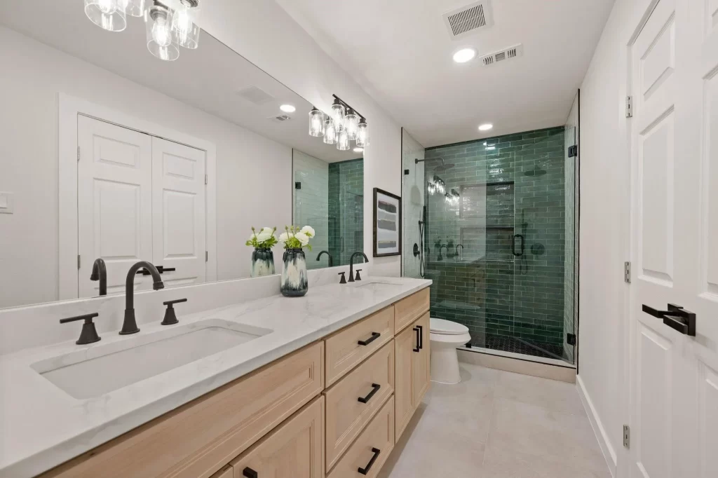 Dallas bathroom remodel with green subway tile and frameless glass shower